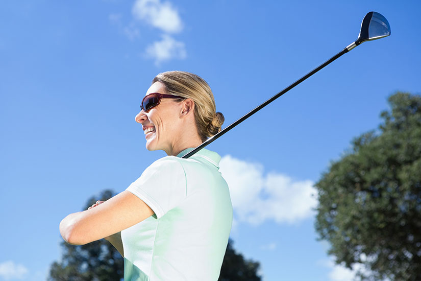 female golfer in sunglasses