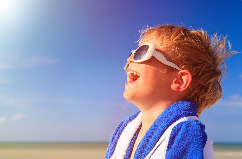 happy boy laughing in sunglasses